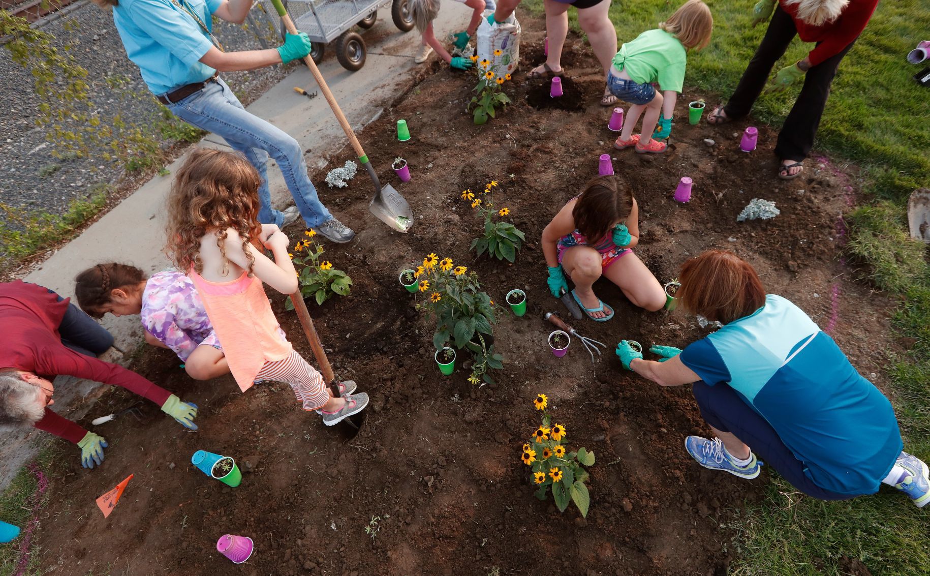 Girl Scouts plant flowers in Billings Depot Pocket Park
